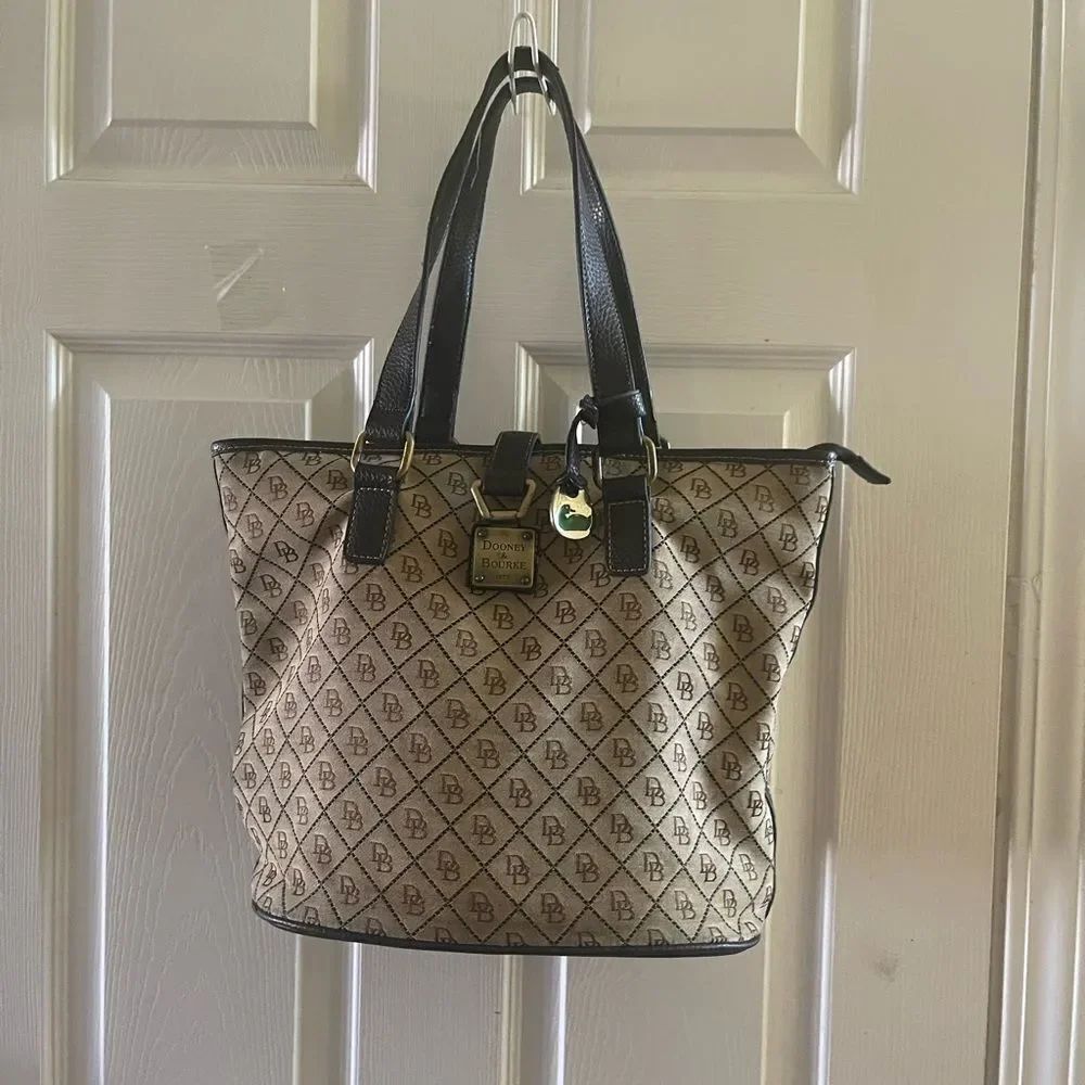 Dooney & Bourke Monogrammed Tan &Brown bucket style tote antique hardwares.